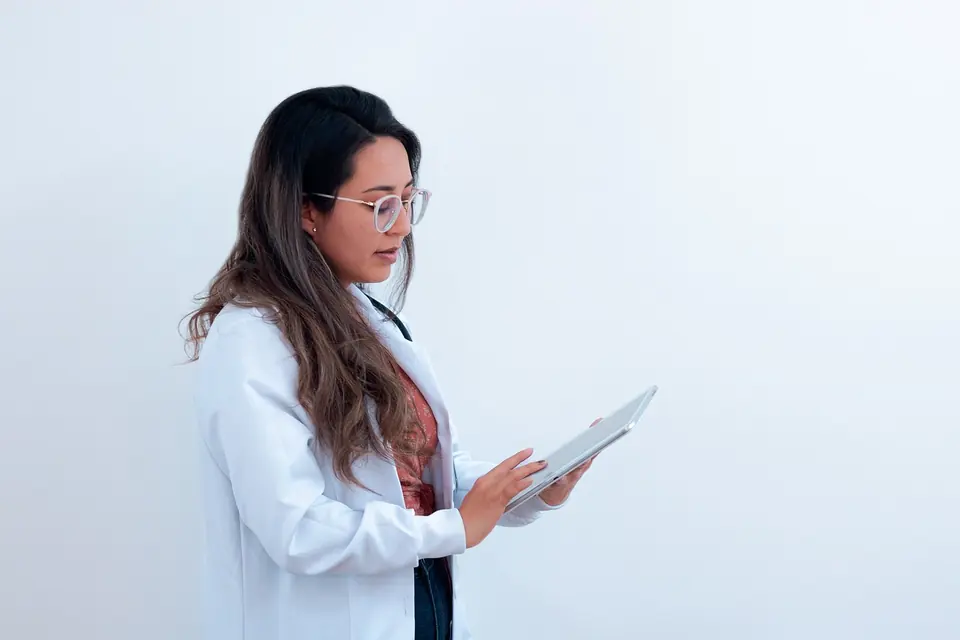 A doctor reading patient records on a tablet